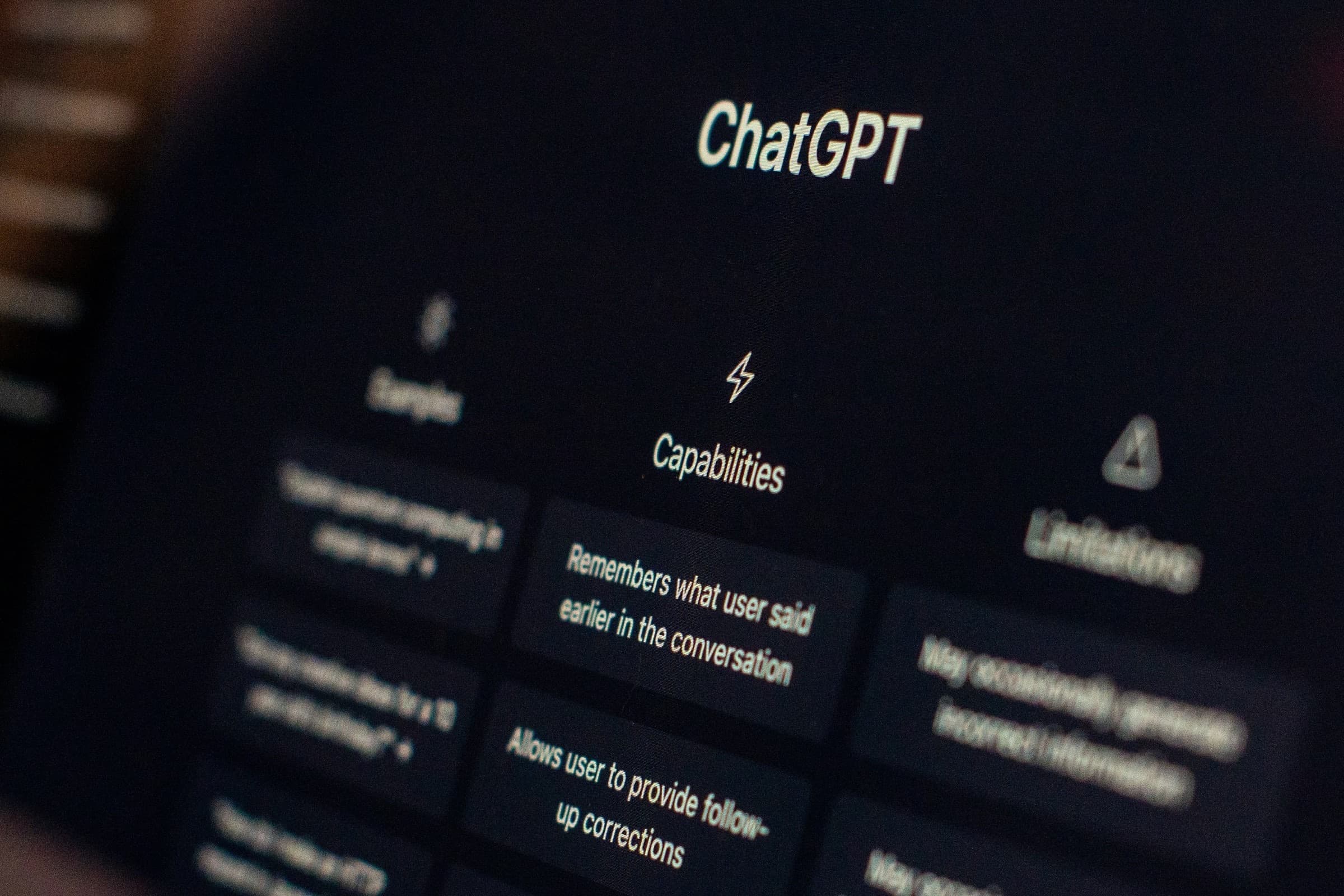 Close-up of a laptop screen showing the ChatGPT interface Capabilities and Limitations menu