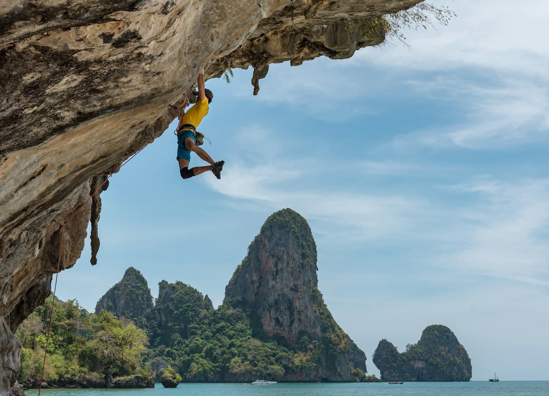 Rock climber ascending a steep granite face with technical climbing gear